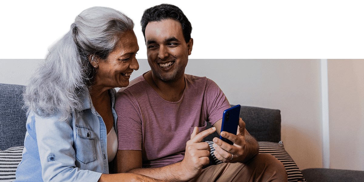 A mother and son reviewing information for her appointment in the doctors waiting room. 
