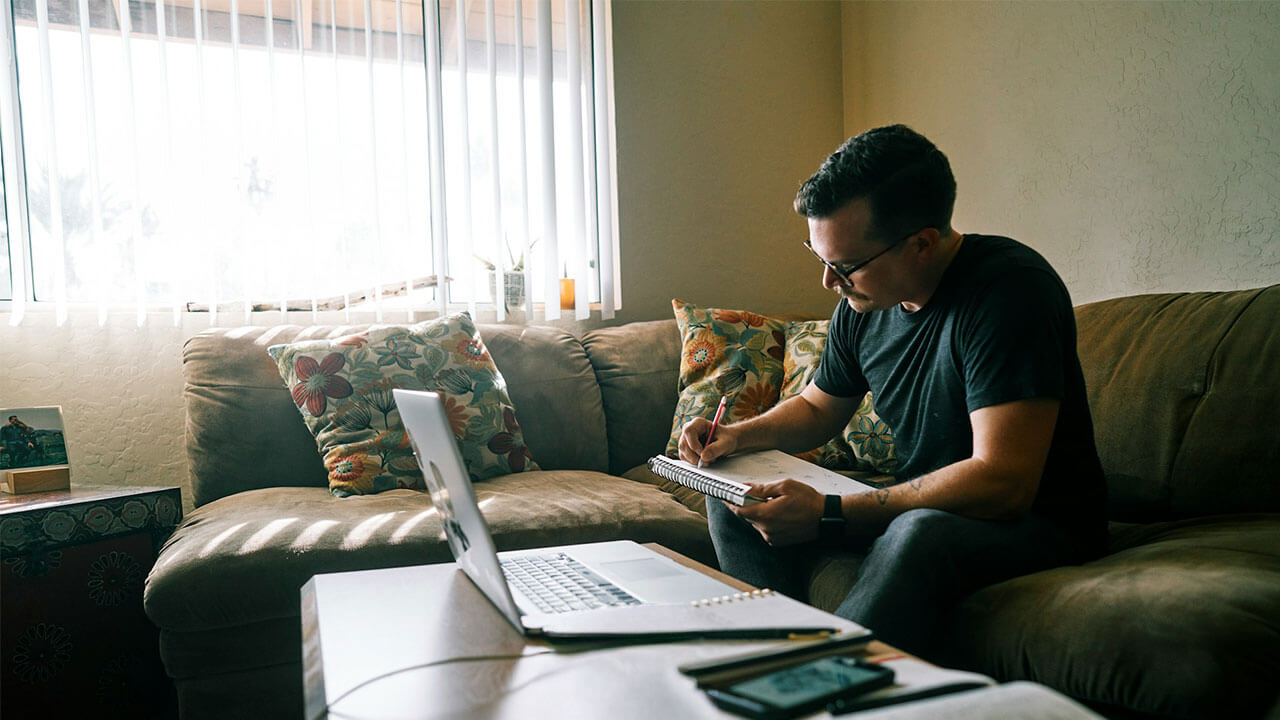 Man reviewing neurology handouts on his couch 